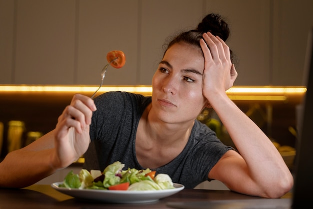 Woman trying to eat healthy at home