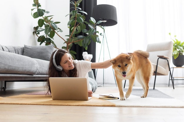 Woman trying to work next to her dog