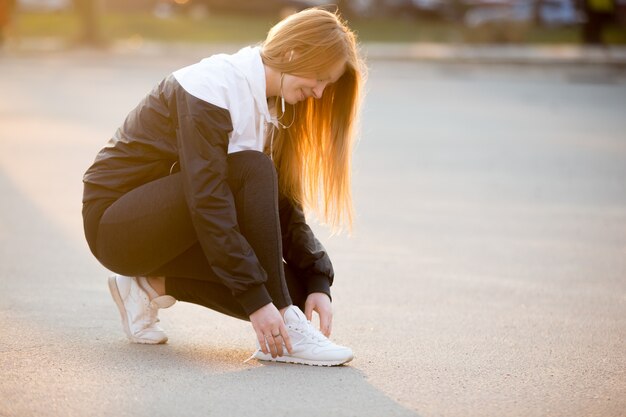 Woman tying shoelaces