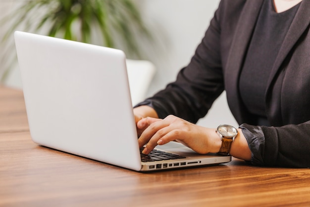 Woman typing on laptop in office