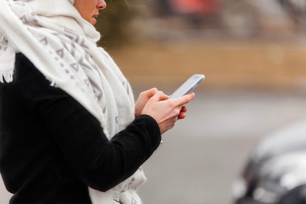 Woman typing in smartphone