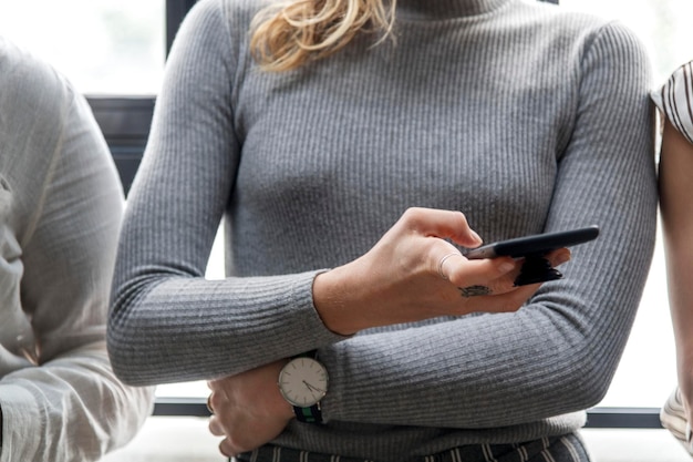 Free photo woman typing on a smartphone