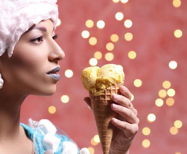 Free photo woman in unusual dress made of marshmallow and wig of cotton candy