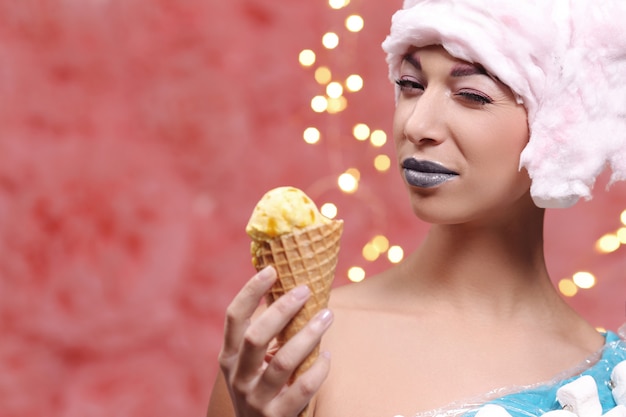 Woman in unusual dress made of marshmallow and wig of cotton candy