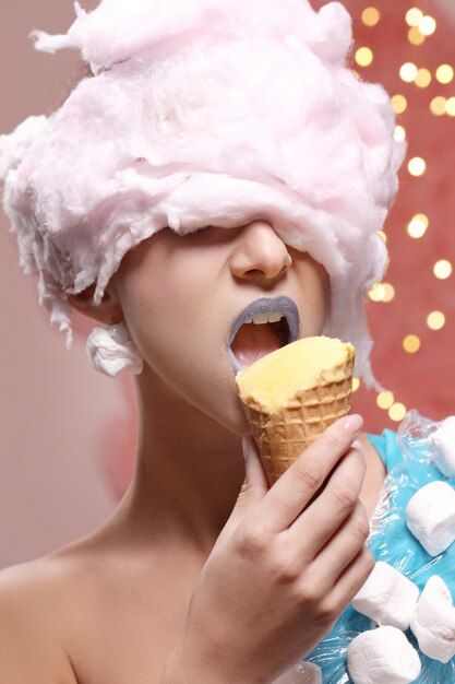 Woman in unusual dress made of marshmallow and wig of cotton candy