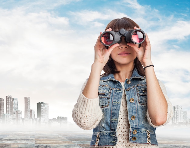 Free photo woman using binoculars with city background