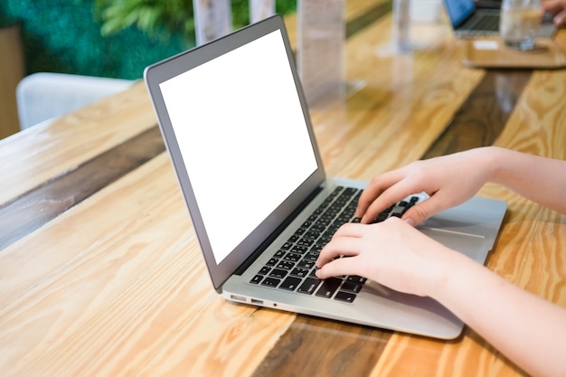 Woman using computer laptop in coffee shop