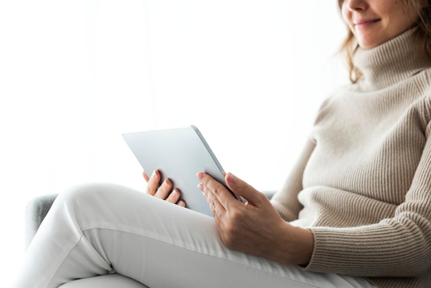 Woman using digital tablet on a couch