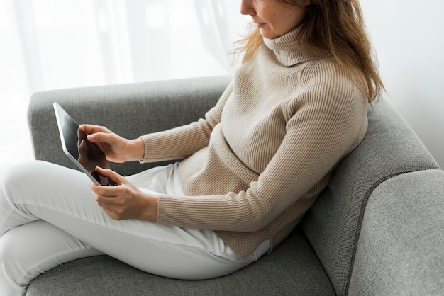 Woman using digital tablet on a couch