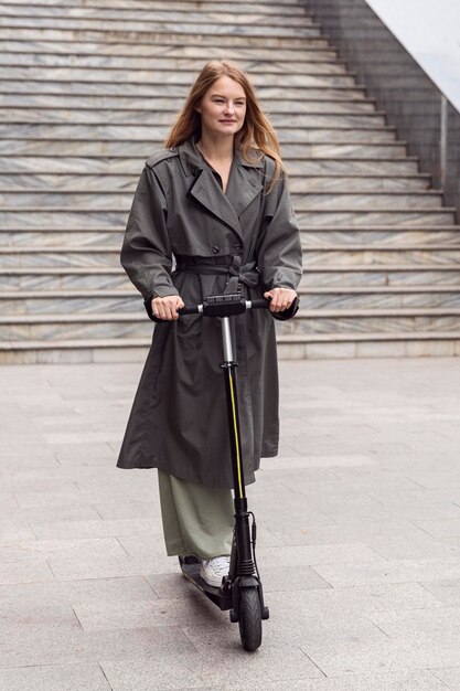 Woman using electric scooter outdoors