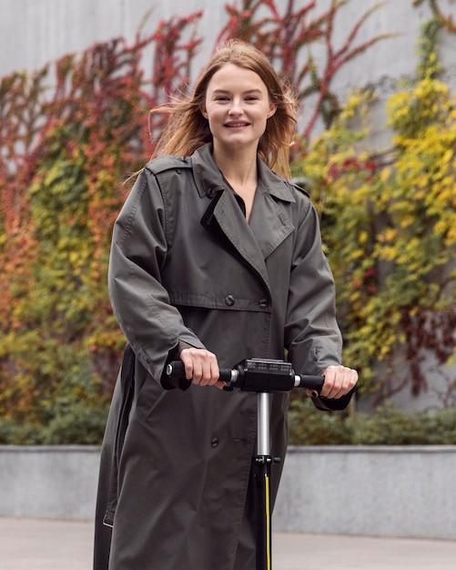 Woman using electric scooter outside