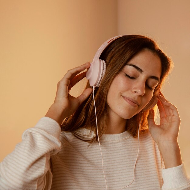 Woman using headphones for music at home