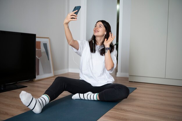 Woman using her smartphone at home during quarantine