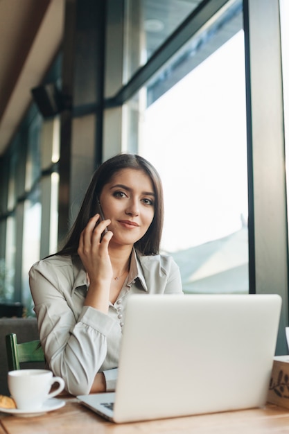 Free Photo woman using laptop in coffee shop