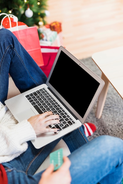 Woman using laptop on couch 