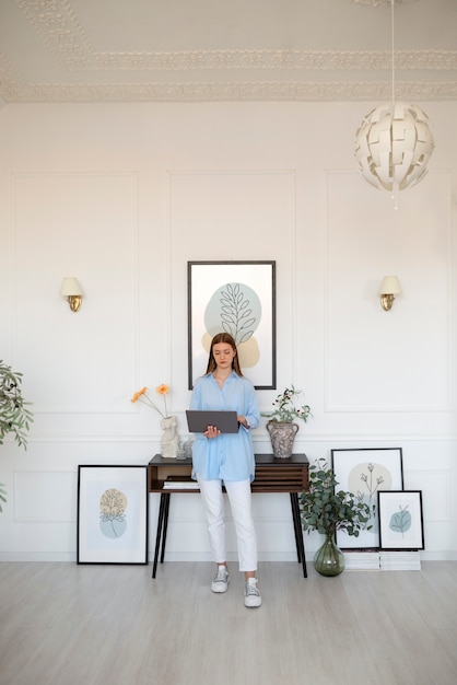 Woman using laptop in minimal decorated room