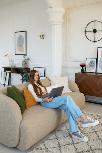 Woman using laptop in minimal decorated room