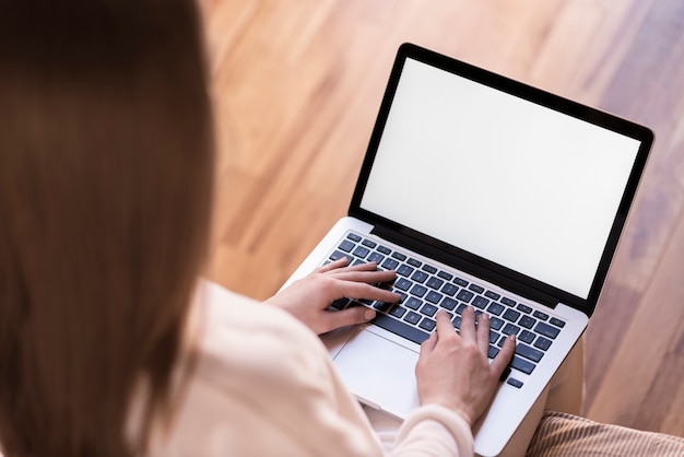 Free photo woman using laptop with blank screen