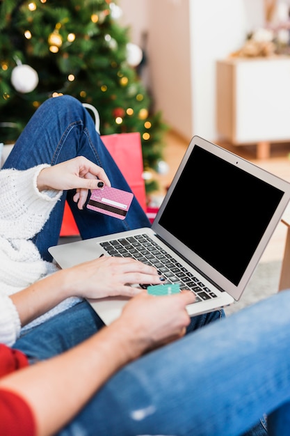 Free Photo woman using laptop with credit card 