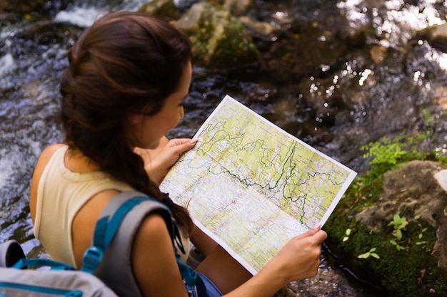 Woman using map to explore nature