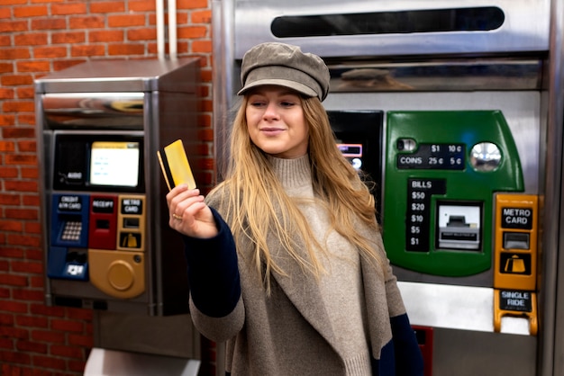 Free Photo woman using a metro card to travel with the subway in the city