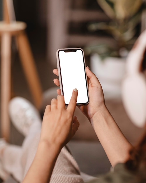 Free Photo woman using modern smartphone and headphones at home