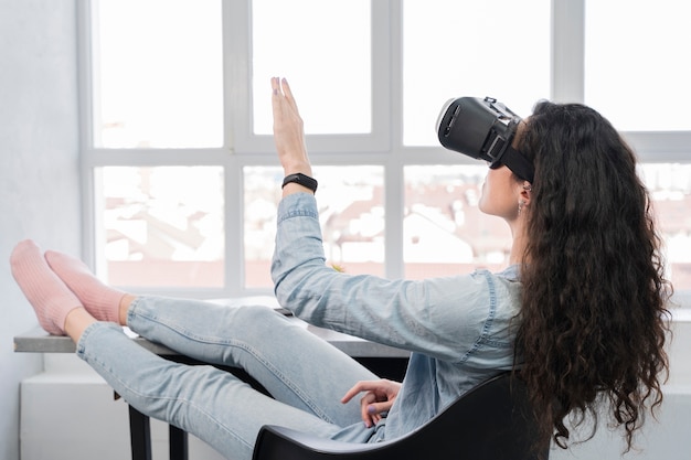 Free photo woman using new tech virtual reality headset