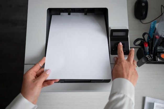 Free photo woman using printer while working in the office