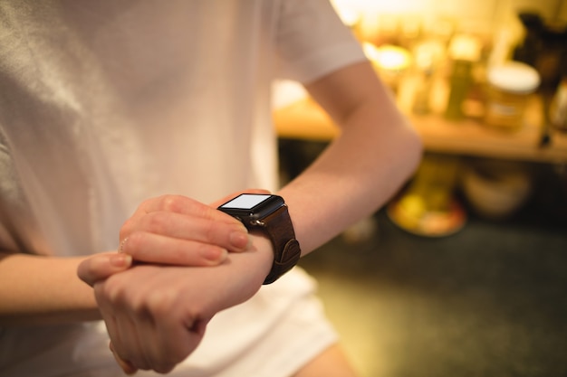 Woman using smart watch at home