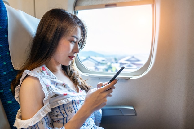 Woman using smartphone in the train.