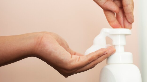 Woman using soap to clean hands