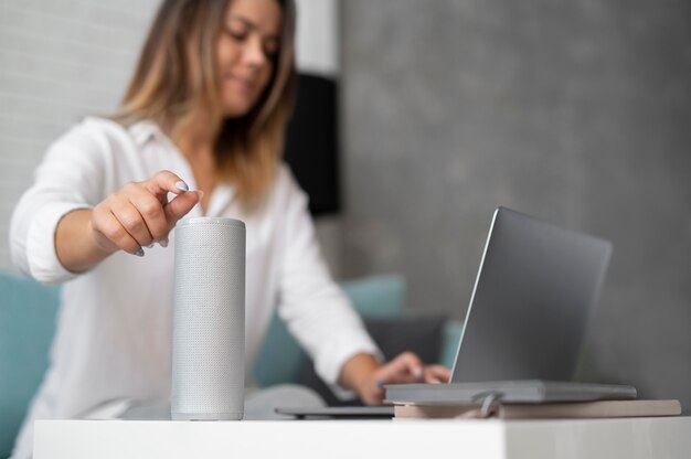 Woman using a speaker digital assistant