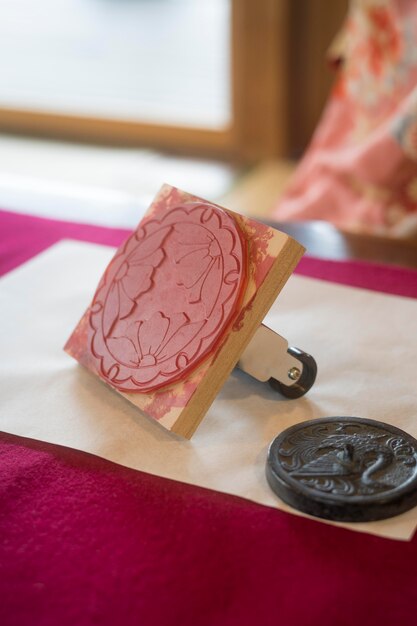 Woman using a stamp on origami paper