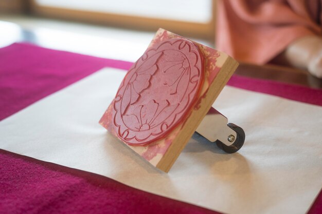 Woman using a stamp on origami paper