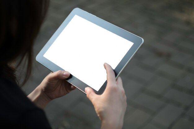 Woman using tablet in garden