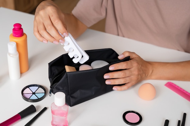 Woman using vanity case high angle