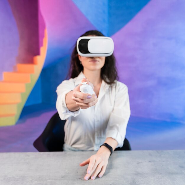 Woman using virtual reality headset and holding a remote