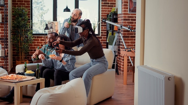 Woman using vr glasses to win video games play, celebrating online victory on tv console with friends. Playing competition and winning, having fun with 3d virtual reality headset.