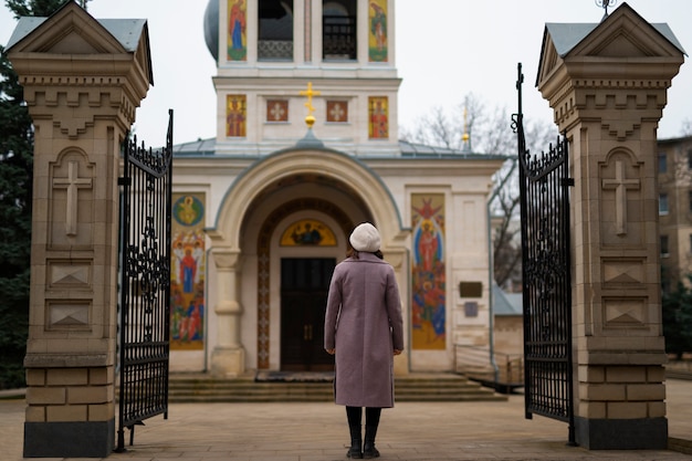 Free photo woman visiting church for religious pilgrimage