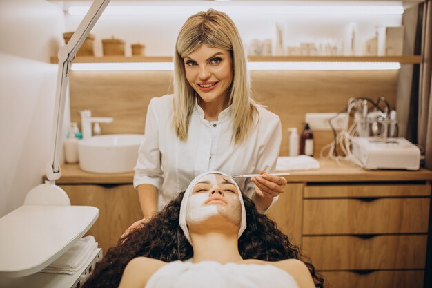 Woman visiting cosmetologist and making rejuvenation procedures