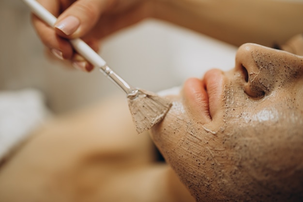 Woman visiting cosmetologist and making rejuvenation procedures