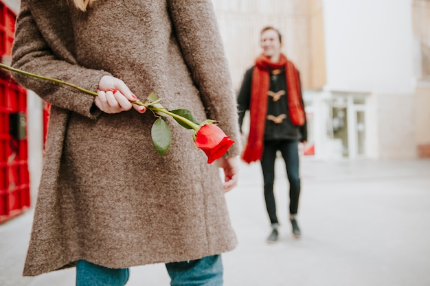 Woman waiting man with rose