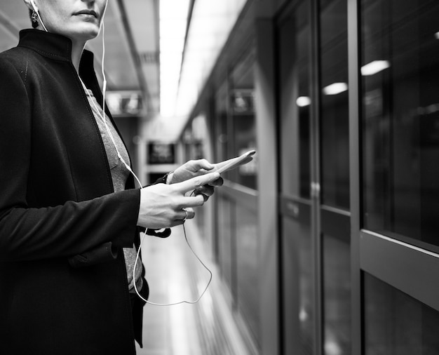 Free photo woman waiting subway terminal transportation concept