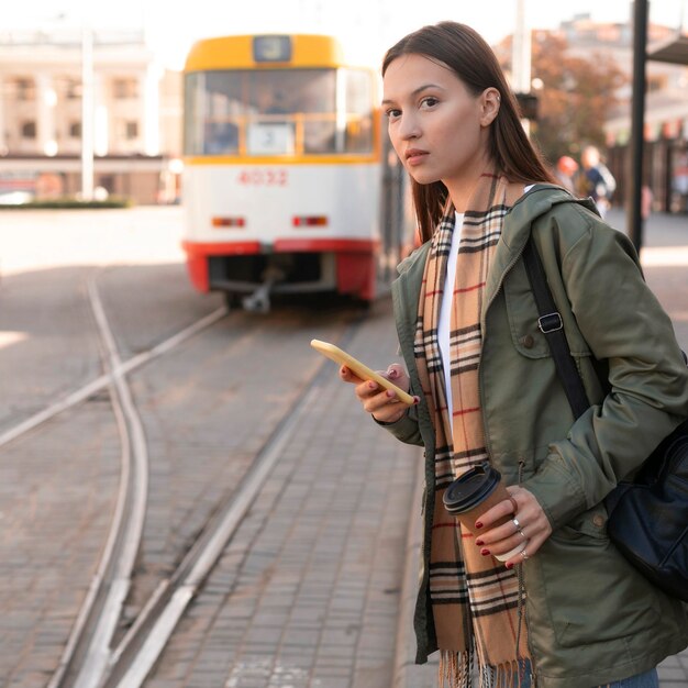 Free Photo woman waiting in the tramway station