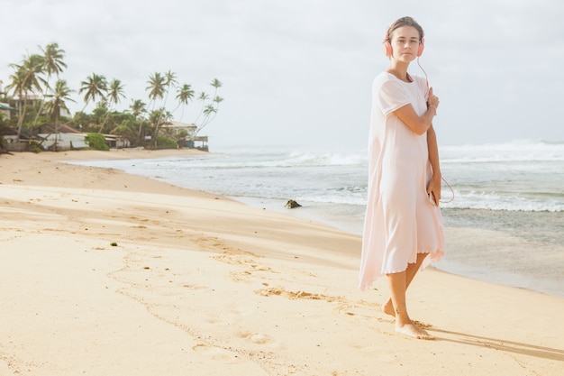 Woman walking on the beach sand