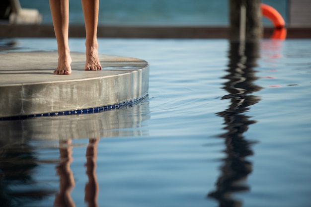 Woman walking by the pool during vacation