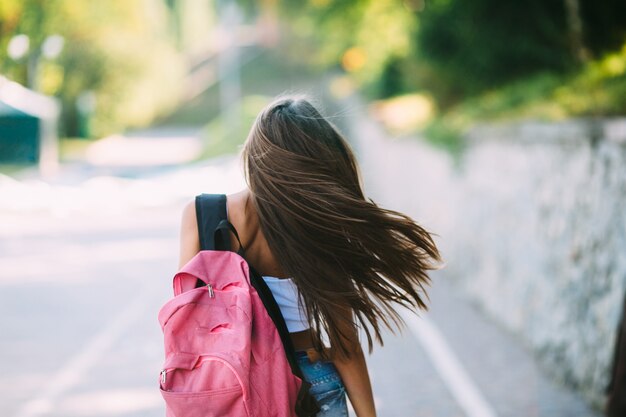 Woman walking on empty road