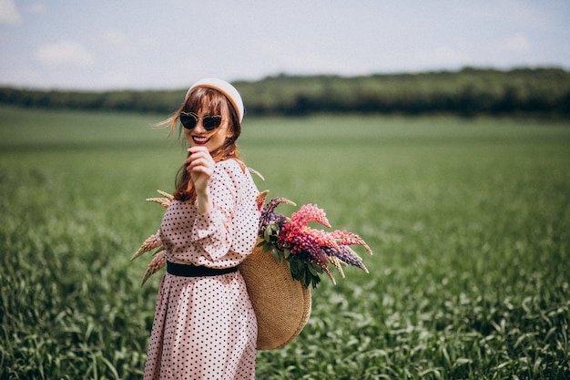 Woman walking in a field with lupinuses