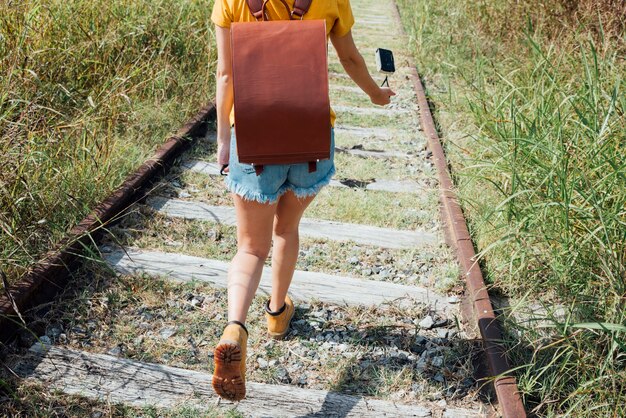 Woman walking through railroad track