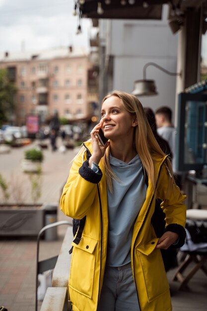 Woman walking and using a smartphone in the street